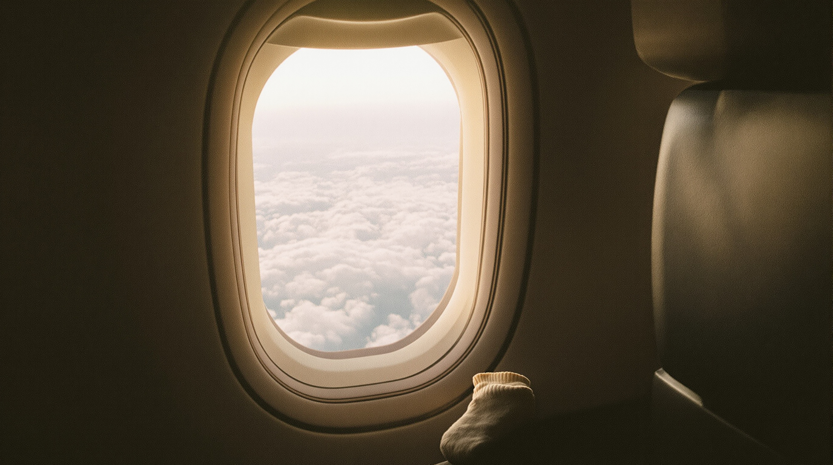 Soft light through an airplane cabin window
